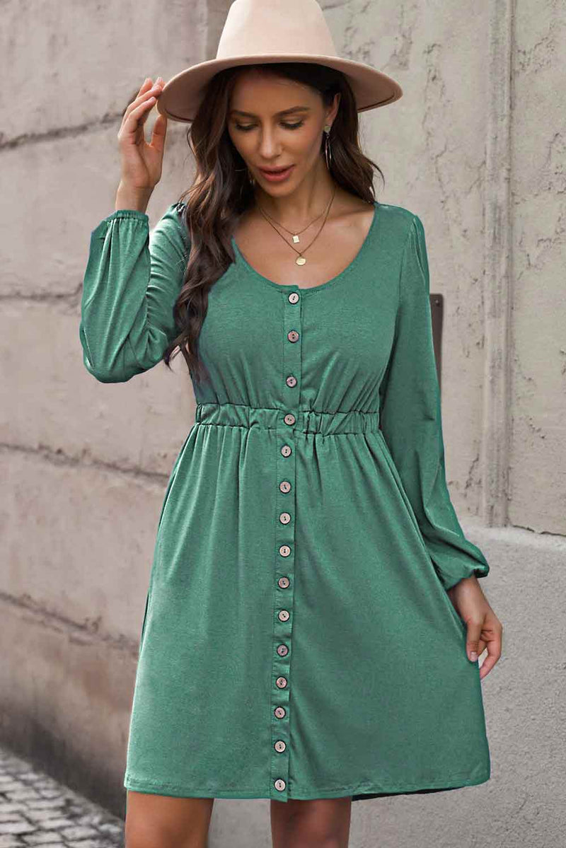 The Sophia Button Dress features stylish buttons down the front and an elastic waistband.